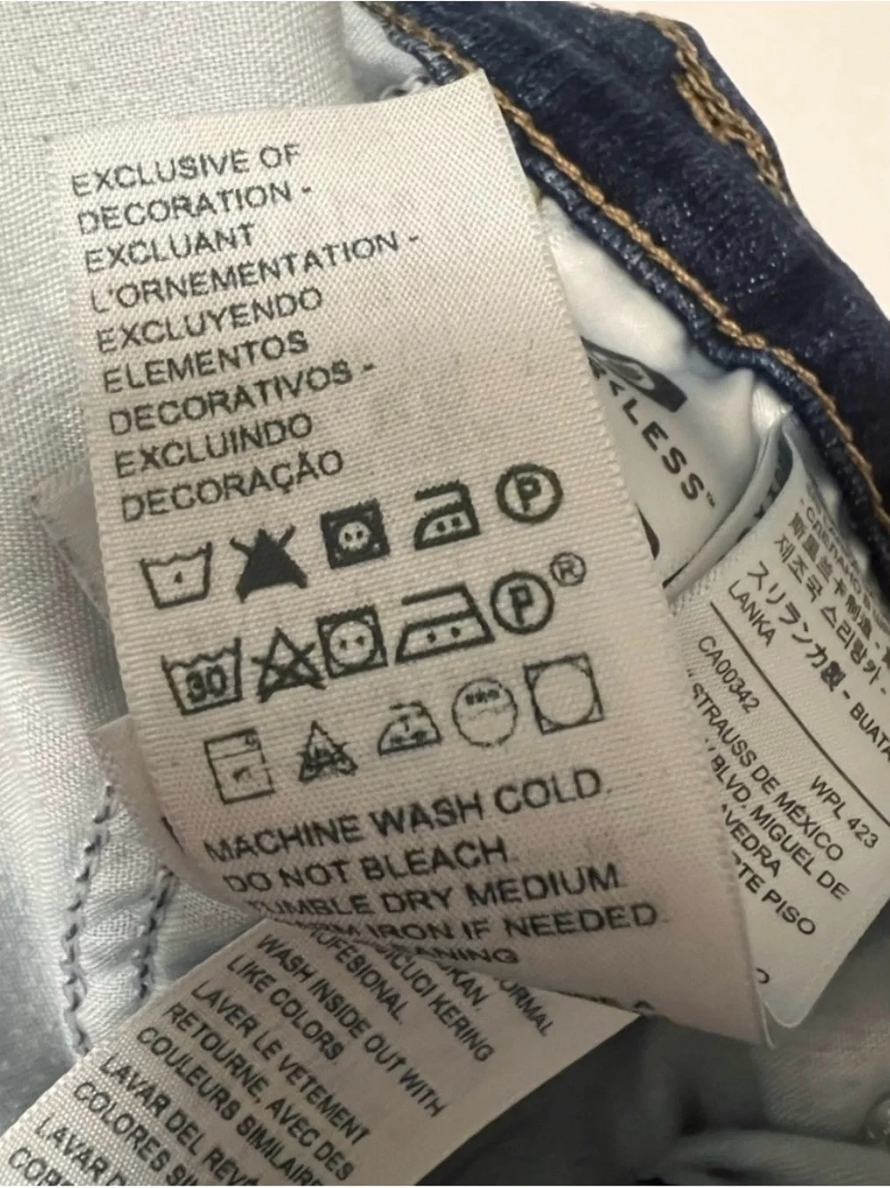 Levi's Dark Blue Denim with Tan Stitch Button Close-Up - Picture 8 of 9